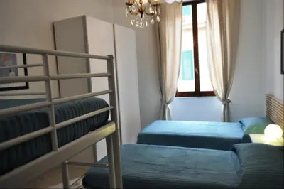 a bedroom with two bunk beds and a chandelier at Casa Domenica in Rome