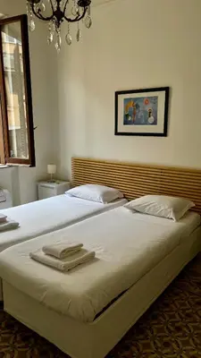 a bedroom with a large bed with two towels on it at Casa Domenica in Rome