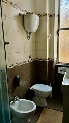 a small bathroom with a toilet and a sink at Casa Domenica in Rome