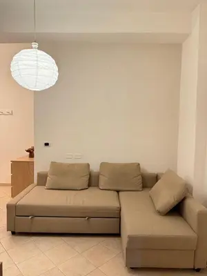 a couch in a living room with a light fixture at Gianicolo Trastevere Exclusive Apartments in Rome