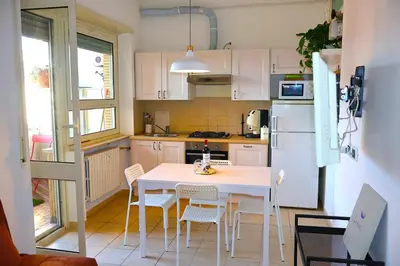 a small kitchen with a white table and chairs at Gianicolo Trastevere Exclusive Apartments in Rome