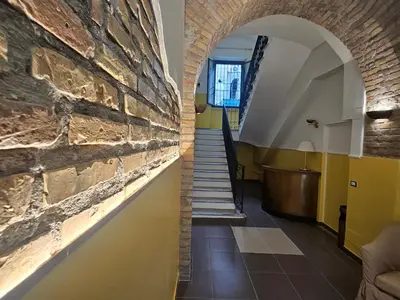 a hallway with a brick wall and a staircase at San Lorenzo Accommodation One in Rome
