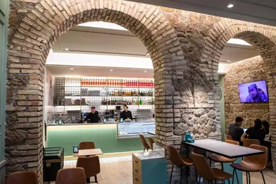 an archway in a restaurant with people sitting at tables at San Lorenzo Accommodation One in Rome