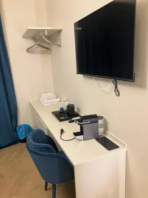 a room with a desk with a television and a chair at Esquilino rooms in Rome