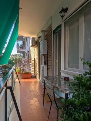 a balcony with a glass table and a window at Domus Valle Aurelia - Vaticano - Metro Linea A in Rome