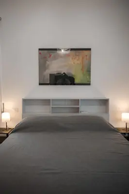 a bedroom with a bed and a tv on the wall at Domus Valle Aurelia - Vaticano - Metro Linea A in Rome