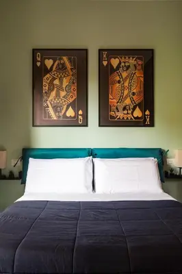 two framed pictures above a bed in a bedroom at Monteverde Private Terrace in Rome