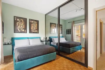 a bedroom with two beds and a mirror at Monteverde Private Terrace in Rome