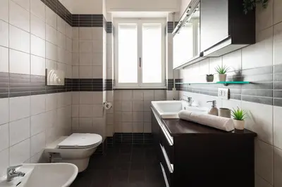 a bathroom with a sink and a toilet and a window at Monteverde Private Terrace in Rome