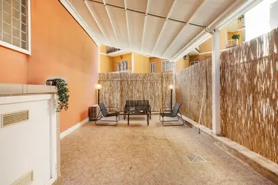 a hallway with chairs and a table in a building at Monteverde Private Terrace in Rome