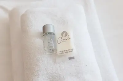 a bottle of soap sitting on top of a towel at AnnaMarco Apartment in Rome