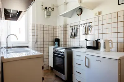 a small kitchen with a stove and a sink at AnnaMarco Apartment in Rome