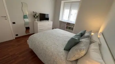 a bedroom with a bed with pillows and a television at Civico 10 Home in Rome