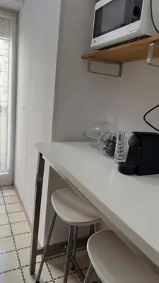a white counter with a microwave on top of it at Civico 10 Home in Rome