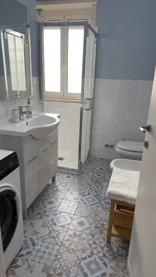 a bathroom with a sink and a washing machine at Civico 10 Home in Rome