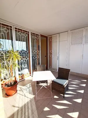 a room with a table and chairs and windows at F&F Rome Apartment - 2 Bedrooms Aurelio Boccea in Rome