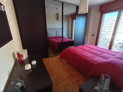 a bedroom with a red bed and a mirror at F&F Rome Apartment - 2 Bedrooms Aurelio Boccea in Rome