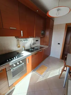 a kitchen with wooden cabinets and a sink at F&F Rome Apartment - 2 Bedrooms Aurelio Boccea in Rome