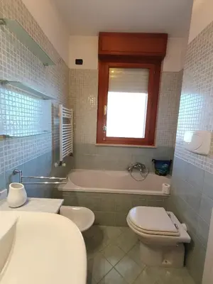 a bathroom with a tub and a toilet and a sink at F&F Rome Apartment - 2 Bedrooms Aurelio Boccea in Rome