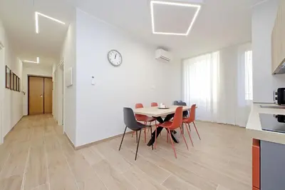 a kitchen and dining room with a table and chairs at 4BNB - Stylish Spacious Apartment near Vatican in Rome