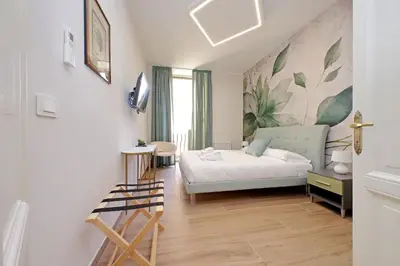 a bedroom with a bed and a desk in a room at 4BNB - Stylish Spacious Apartment near Vatican in Rome