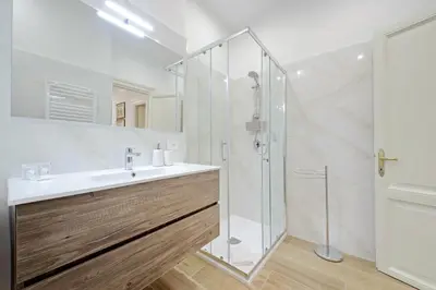 a bathroom with a sink and a shower at 4BNB - Stylish Spacious Apartment near Vatican in Rome