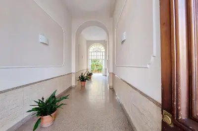 an empty hallway with potted plants in a building at 4BNB - Stylish Spacious Apartment near Vatican in Rome