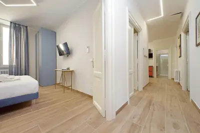 a large room with a bed and a hallway at 4BNB - Stylish Spacious Apartment near Vatican in Rome
