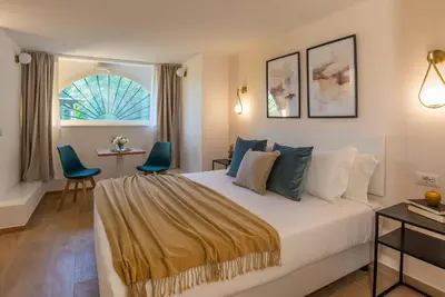 a hotel room with a bed and a table and chairs at 94Rooms Roma Nord - Flaminia in Rome