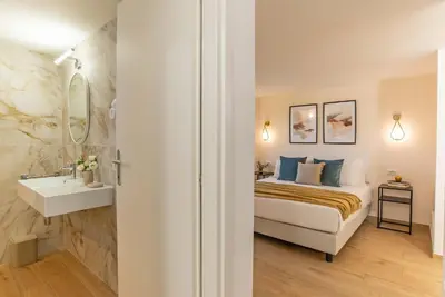 a bedroom with a bed and a sink and a mirror at 94Rooms Roma Nord - Flaminia in Rome