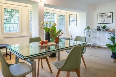 a dining room with a glass table and chairs at 94Rooms Roma Nord - Flaminia in Rome