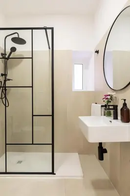 a bathroom with a glass shower and a sink at Palomba Boutique Apartment in Rome