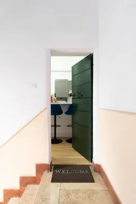 a door leading into a room with a desk at Palomba Boutique Apartment in Rome