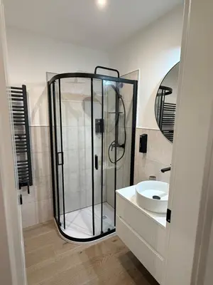 a bathroom with a shower and a sink at Vita Lux Vatican Suites in Rome
