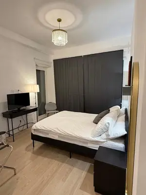 a bedroom with a large bed with a black headboard at Vita Lux Vatican Suites in Rome