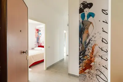a room with a painting of a woman on the wall at Vittoria C Elegant Apt Near Vatican & Dome View in Rome