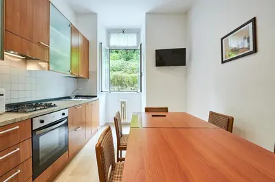 a kitchen with a large wooden table and chairs at Relax a Trastevere in Rome