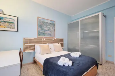 a bedroom with a bed with two towels on it at Penthouse 5 minutes from the Vatican - 5 bedrooms & 4 bathrooms in Rome