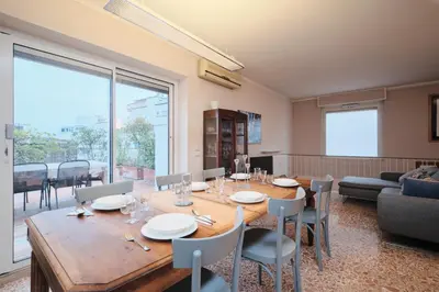 a dining room with a table and chairs at Penthouse 5 minutes from the Vatican - 5 bedrooms & 4 bathrooms in Rome