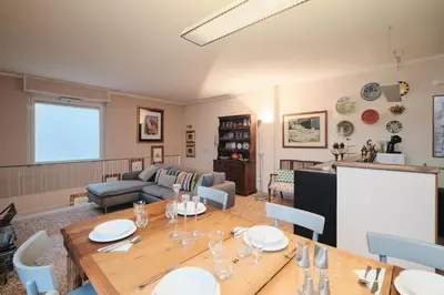 a living room with a table and a couch at Penthouse 5 minutes from the Vatican - 5 bedrooms & 4 bathrooms in Rome