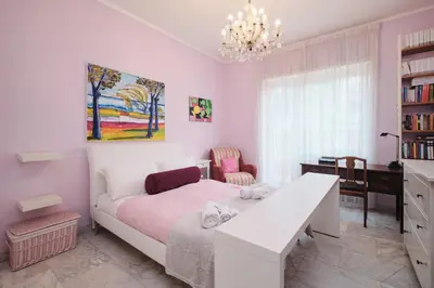 a bedroom with a white bed and a desk at Penthouse 5 minutes from the Vatican - 5 bedrooms & 4 bathrooms in Rome