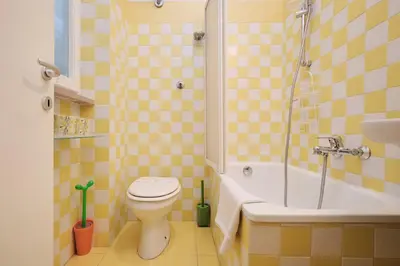 a bathroom with a toilet and a tub and a sink at Penthouse 5 minutes from the Vatican - 5 bedrooms & 4 bathrooms in Rome
