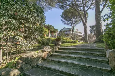 a set of stone stairs in a park with trees at Rome Garden Hill in Rome