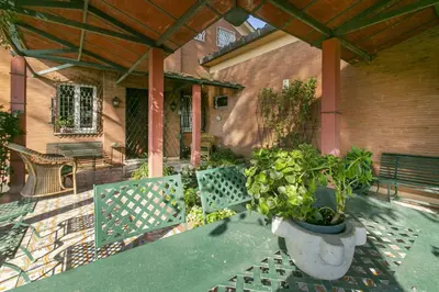 a patio with two benches and a table with plants at Rome Garden Hill in Rome