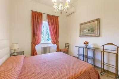 a bedroom with a red bed and a window at Rome Garden Hill in Rome