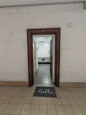 an open door to a room with a hello sign on the floor at Emilia's Dream Apartment in Rome