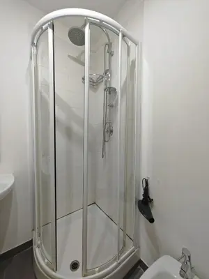 a glass shower in a bathroom with a toilet at Emilia's Dream Apartment in Rome