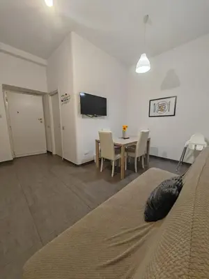 a room with a bed and a table and a tv at Emilia's Dream Apartment in Rome