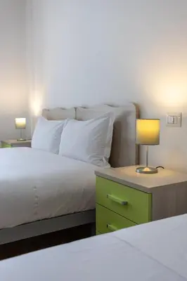 a bedroom with a bed and a table with a lamp at Veturia in Rome