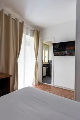 a bedroom with a bed and a large window at Veturia in Rome